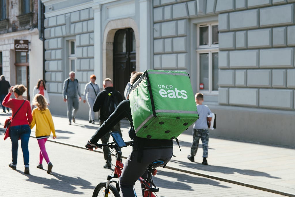An Uber Eats delivery courier heading to a destination on their bike.