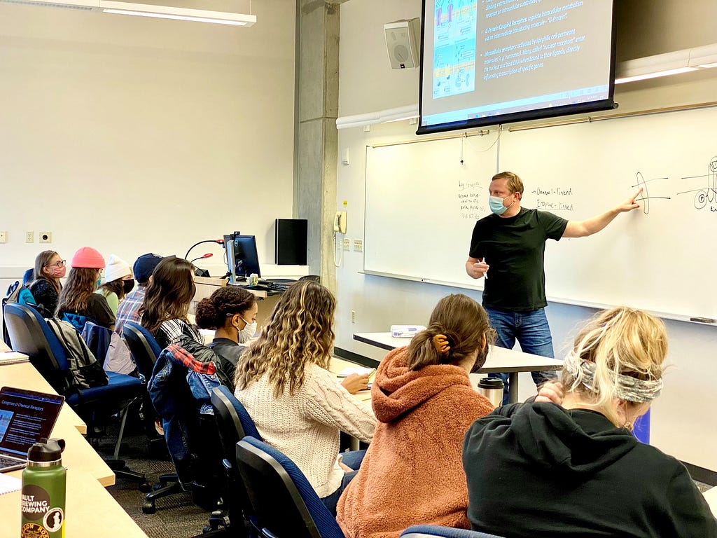Western Associate Professor of Psychology Jeff Carroll teaches students at the whiteboard during a fall quarter 2021 class.