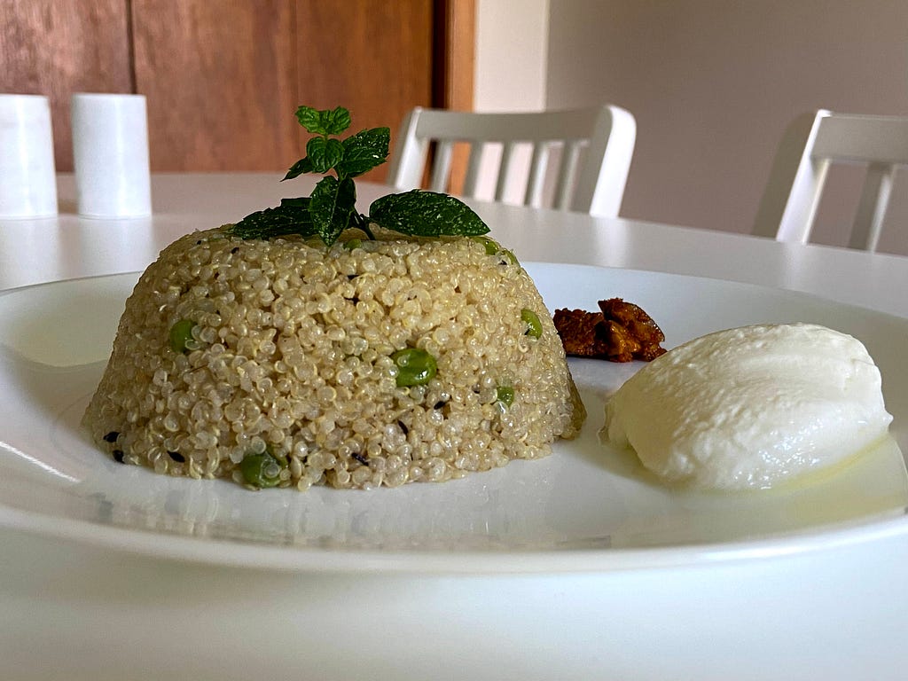 Quinoa Pulao served with a dollop of yogurt and mango pickle.