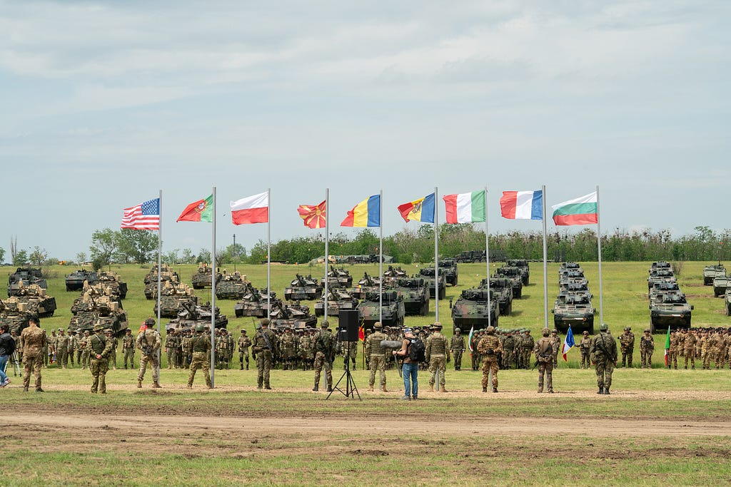 Soldiers and armored vehicles are staged for the opening ceremony for exercise Saber Guardian 23 in Smardan, Romania, May 29, 2023. Photo by Capt. Avery Smith/U.S. Army