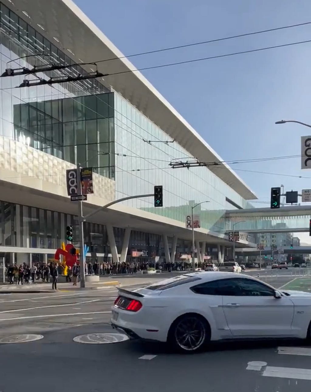 An image of the outside of the Moscone Convention Center during GDC. The line of people waiting to pick up badges wrapped around the block.