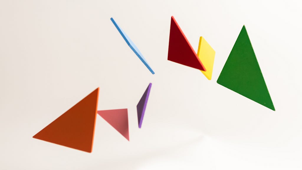 Colorful triangles floating in the air, symbolizing juggling multiple things while preparing for the math SATs.