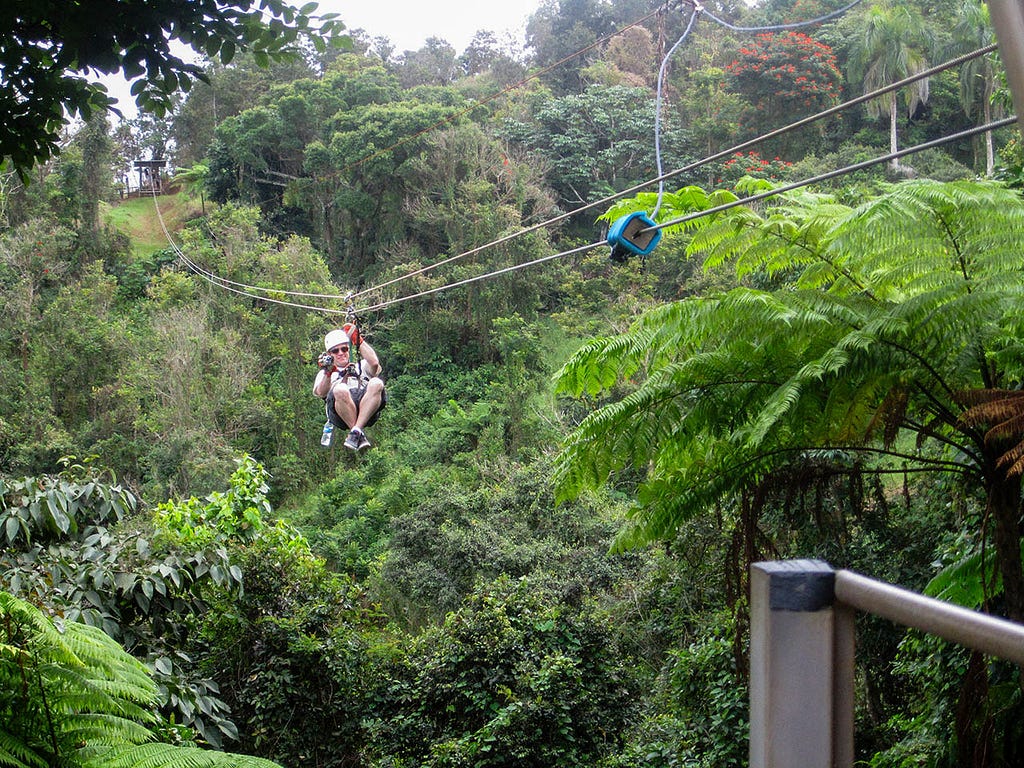 a guy zip-lining through the jungle of toro verde