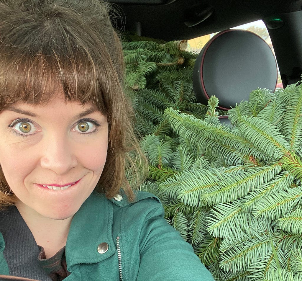 Jen Baker of Lavender Blue Florist with spruce branches in car