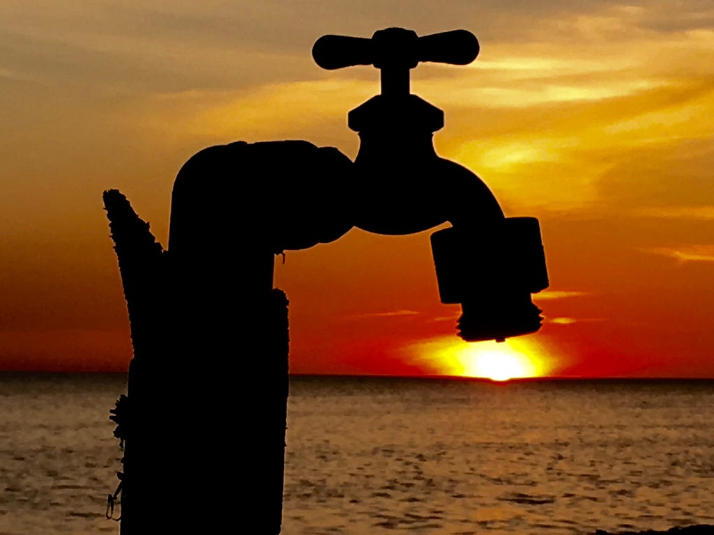 sunset behind a faucet