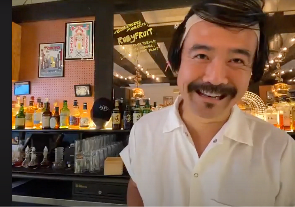 Photo of Masahiro sporting a fun wig, in his bar, Katana Kitten.