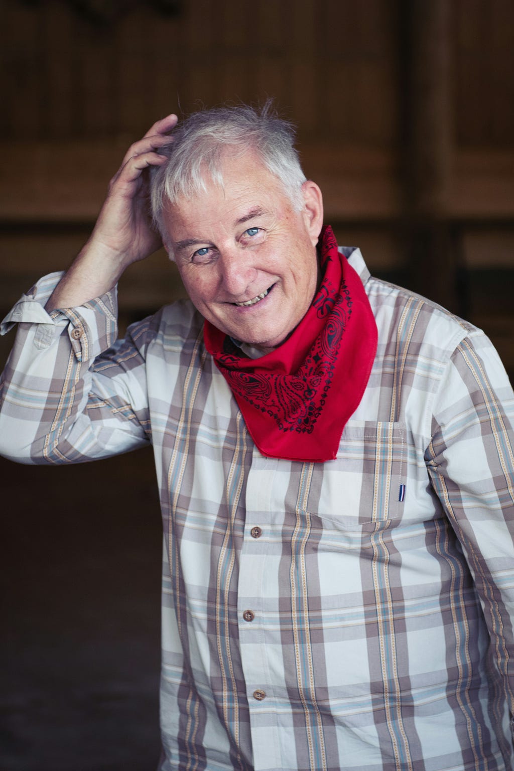 69 year-old man with red bandana around his neck