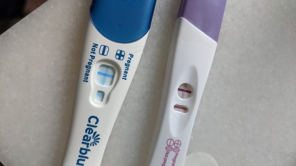 Image of two pregnancy tests, both positive.