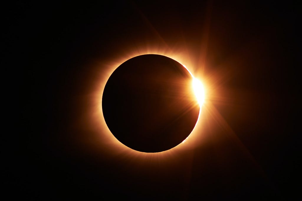 A near total eclipse of the sun shows a ring of fire in the blackness.