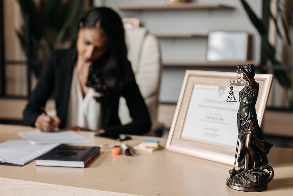 A paper diploma framed on a desk