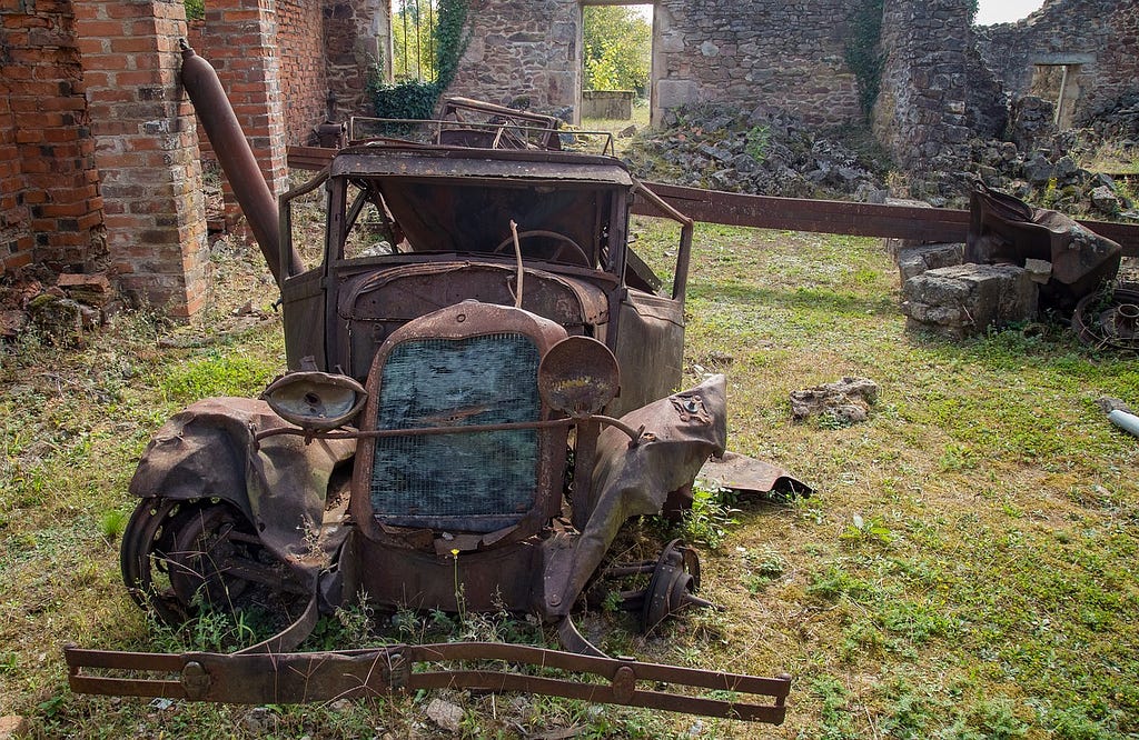 The Decaying Wreckage of an old car at Oradour-sur-Glane-Photo by KANAthecircle