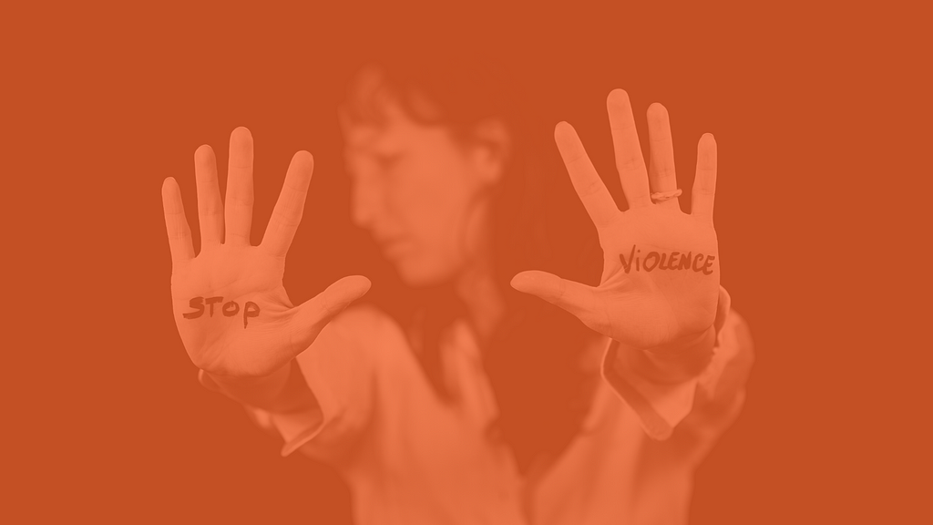 woman holding her hands up with the words STOP VIOLENCE