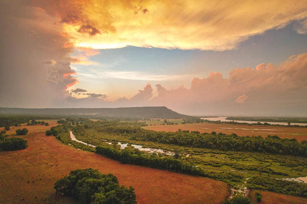 Petit Jean Mountaing and the Arkansas River valley under dramatic clouds and sunset after a summer storm.