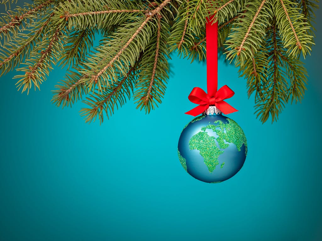 Planet earth as a bauble on a Christmas tree.