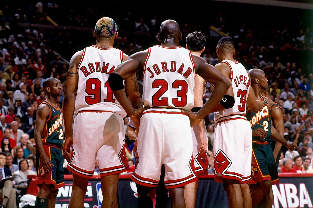 Source: https://www.shoepalace.com/cdn/shop/articles/1996-06-16-0-Gm-6-v-SEA-1996-NBA-Finals-Michael-Jordan-Dennis-Rodman-Scottie-Pippen-NBAE-Andrew-Bernstein_1200x1200.jpg?v=1650053136