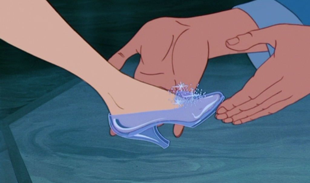 The glass slipper fitting perfectly on Cinderella’s foot.