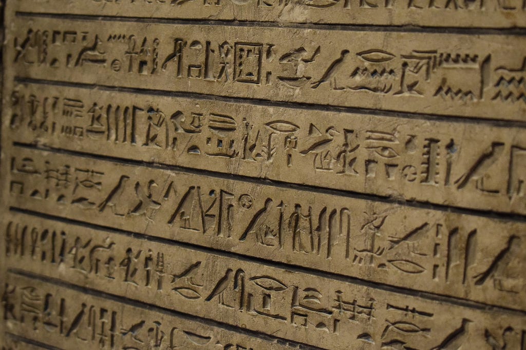 A wall of carved hieroglyphs. Image by RGY23 from Pixabay.