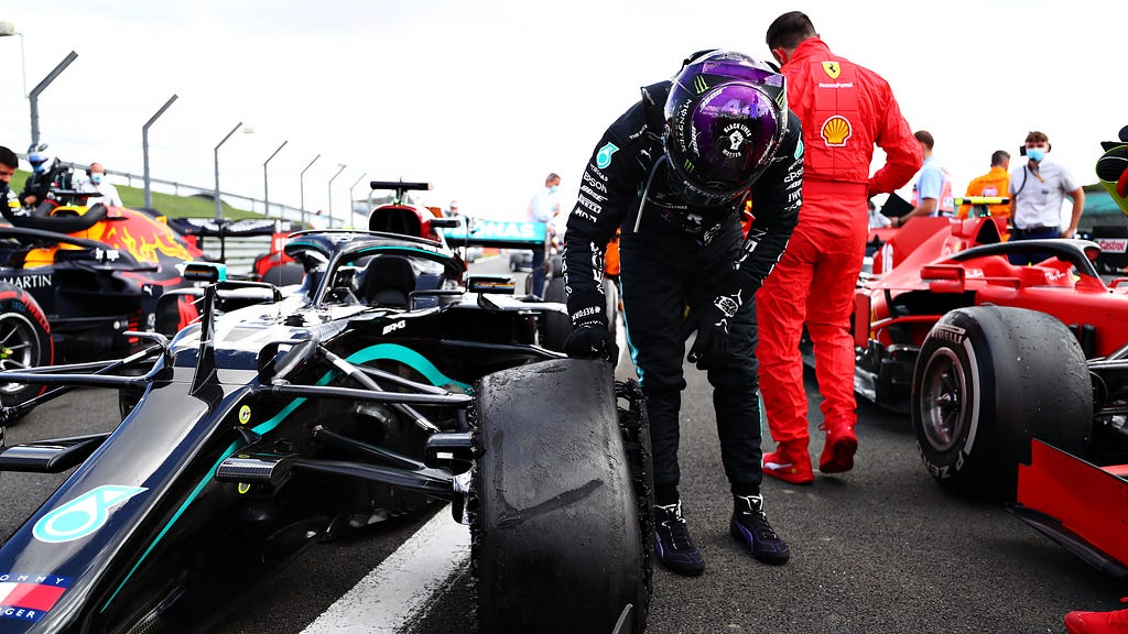 Lewis Hamilton checking the damage of his W11’s front left tyre following his victory at the 2020 British Grand Prix