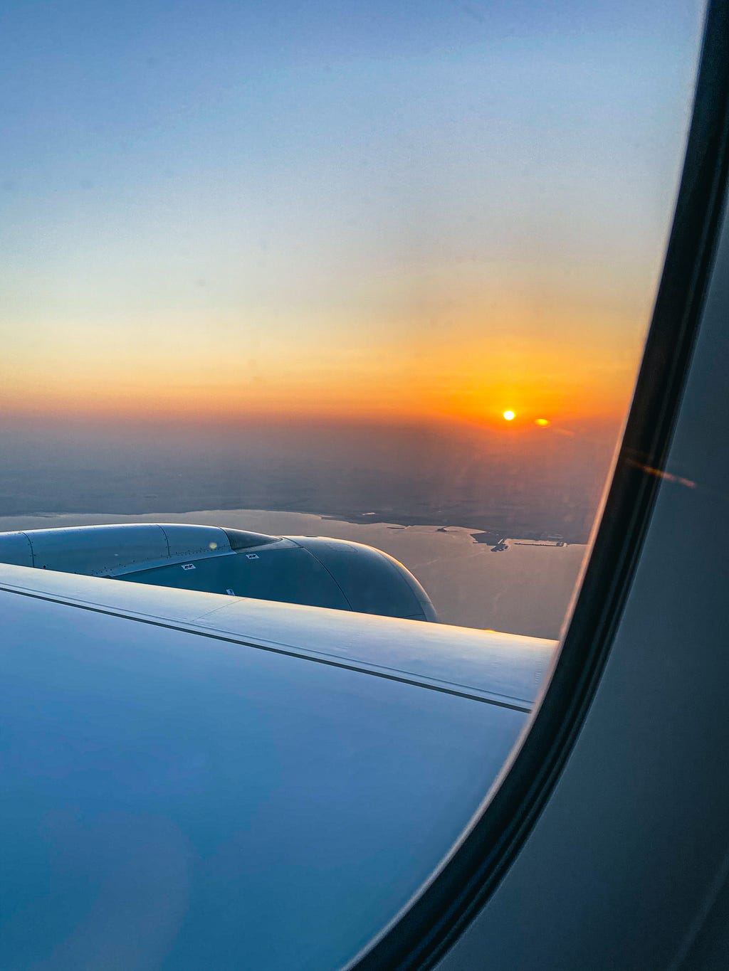 Sunset during my descent into Doha, Qatar. Photo by Author