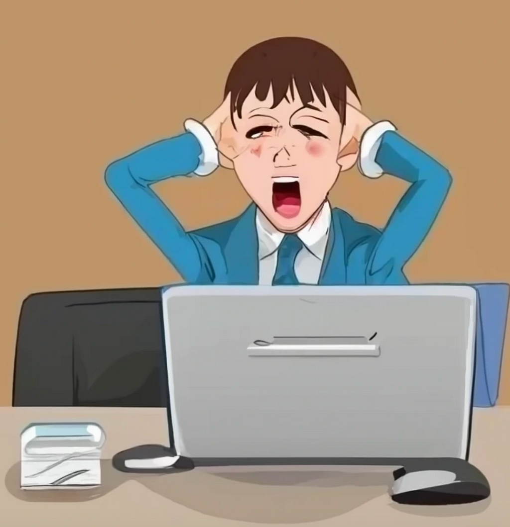 A user holding his ears and clearly stressed at a latop