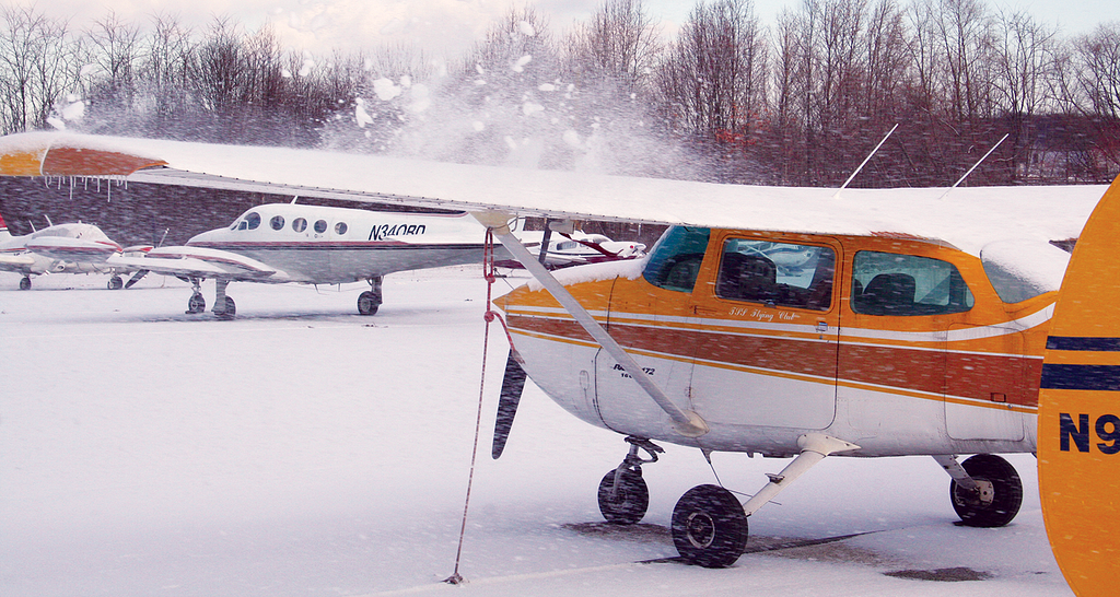 Airplanes with snow on them.