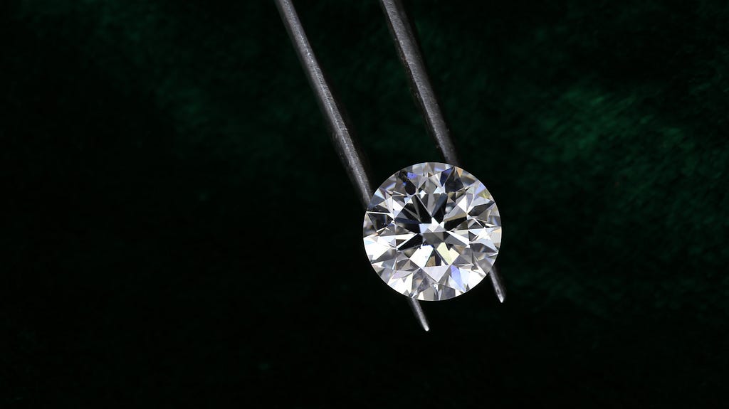 A diamond being picked up very carefully