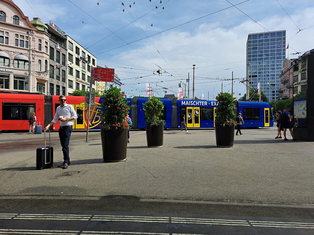 A man standing in front of a colorful train