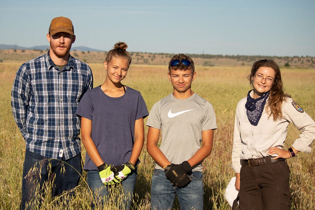 Youth Conservation Corps leader, crew and Refuge Biologist, Jesy Simons, celebrating a successful banding of a juvenile greater Sandhill crane (Grus canadensis tabida) at Modoc National Wildlife Refuge.