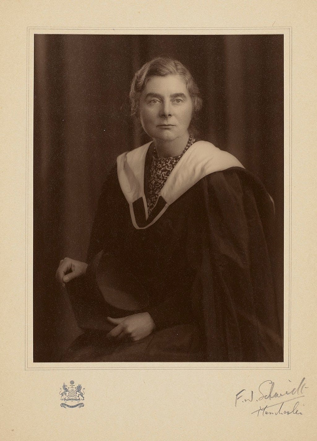 Studio portrait photograph of Margaret Pilkington with cap and gown after receiving her Honorary M.A., 1942