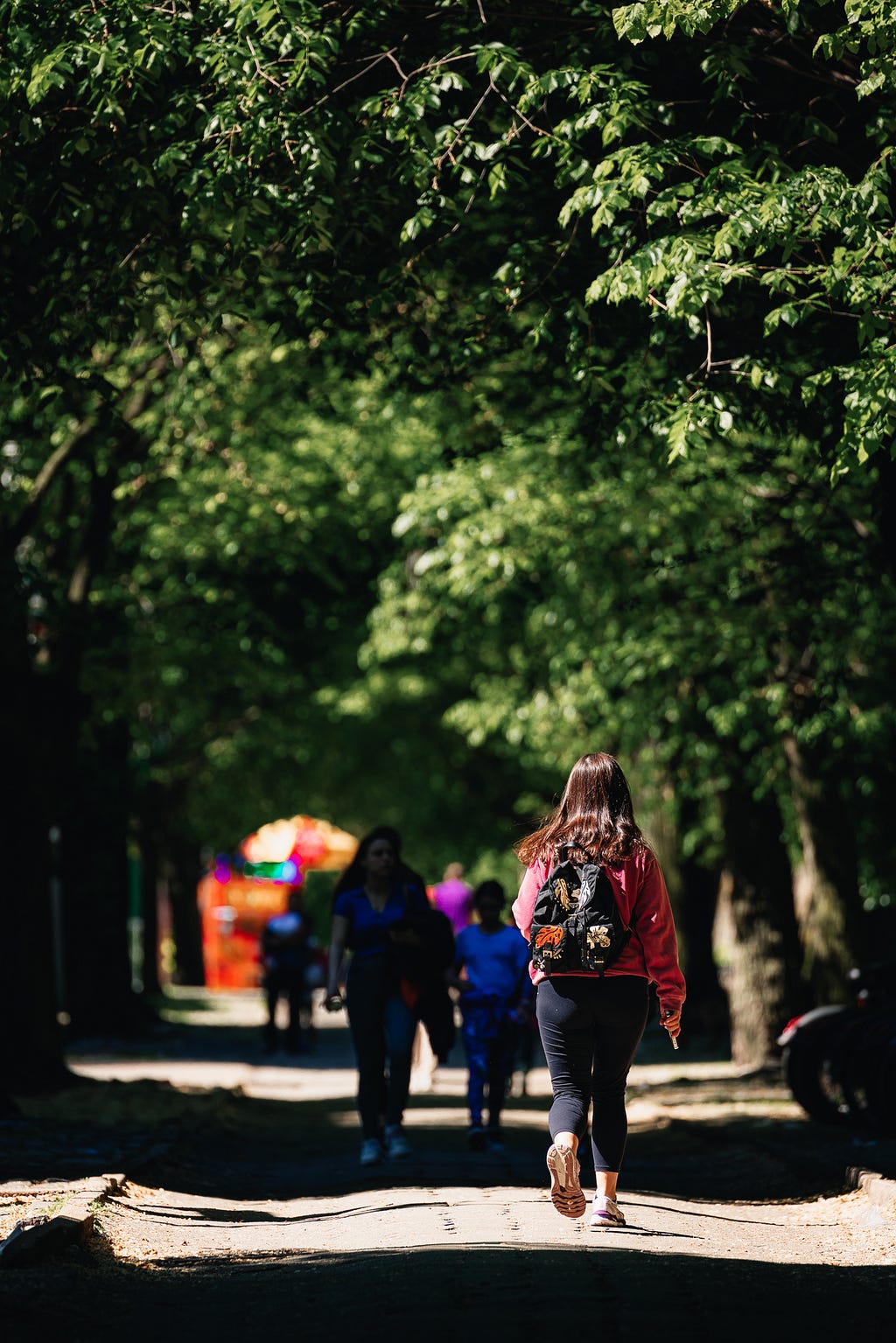 Girl with backpack walking on a sunny day