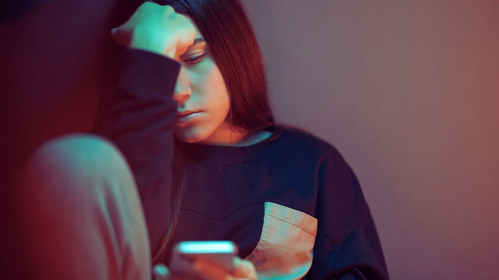 Teenager overusing social media on her smartphone.