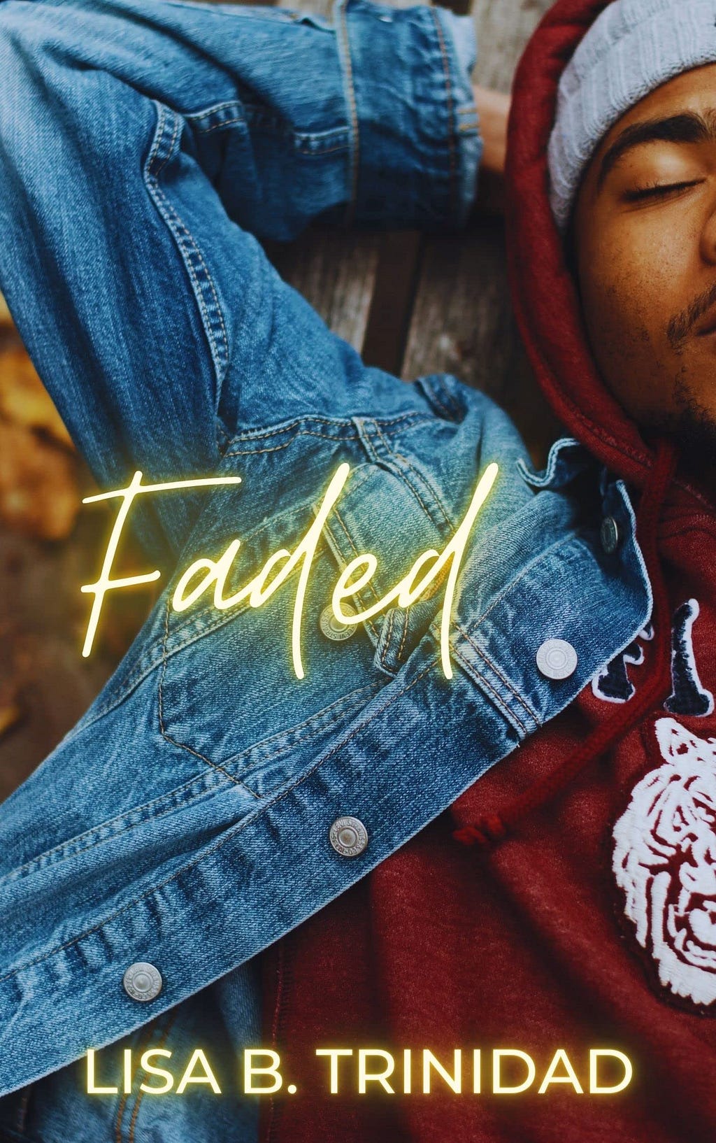 Cover of Faded by Lisa B. Trinidad. Photo of a Black man in a hoodie and denim jacket with his arm over his head. Title and author text.