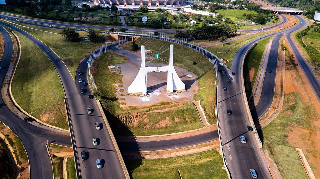 A photo of a monument in Abuja, Nigeria in the middle of two highways.