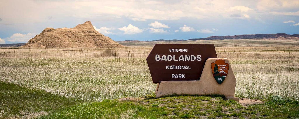 An image of an entrance sign to Badlands National Park.