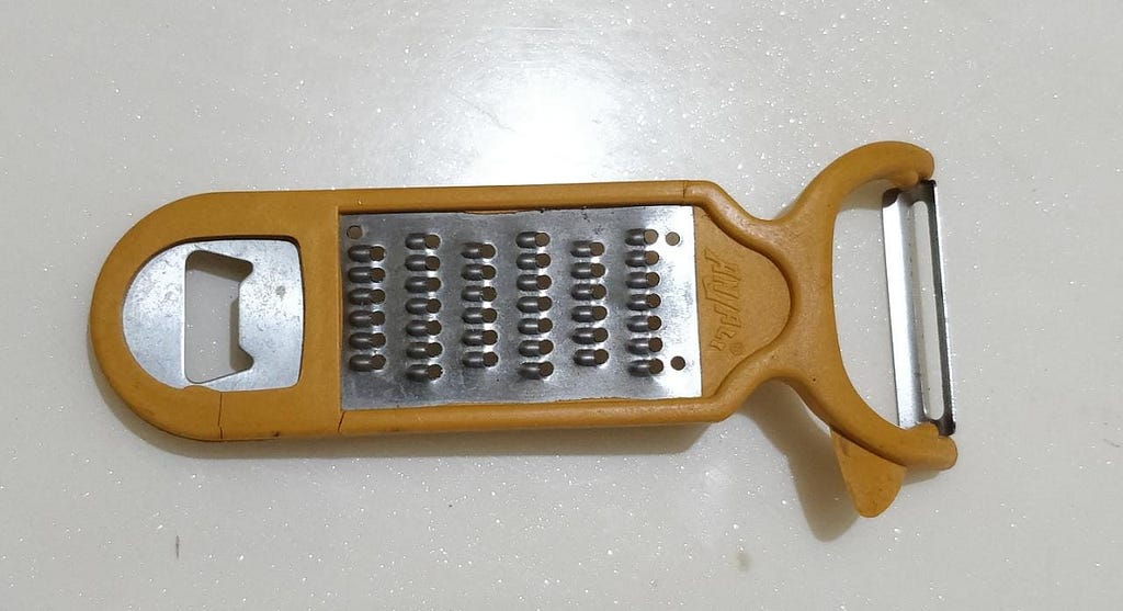 a photo of a peeler with bottle opener.