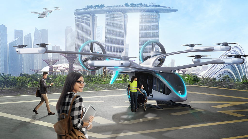 image of the flying car in Singapura. 2 people are approaching the vehicle whi a staff is helping a wheel chair use to board