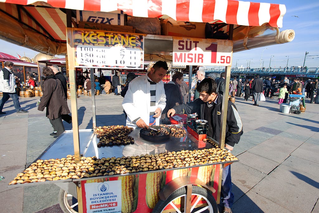 a chestnut cart with an attendant helping a young man