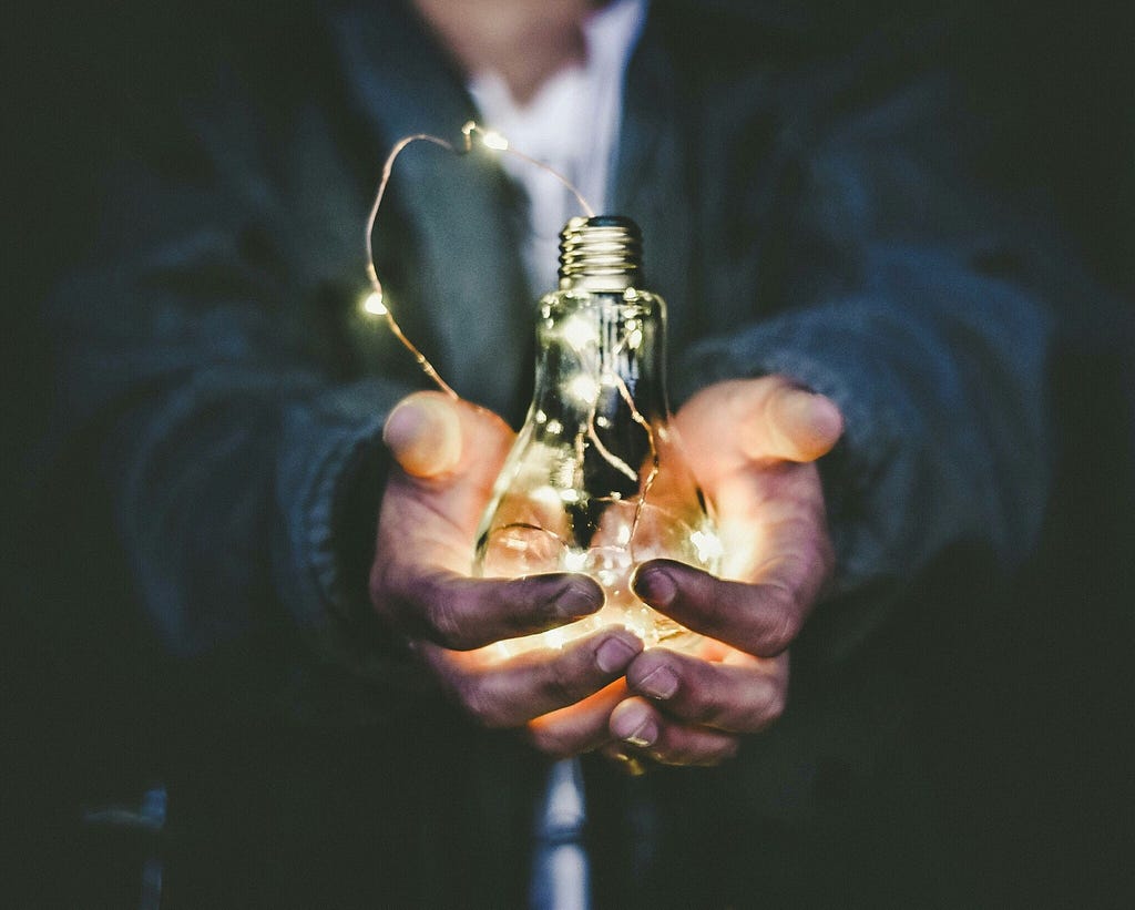 Inventor holding a light bulb