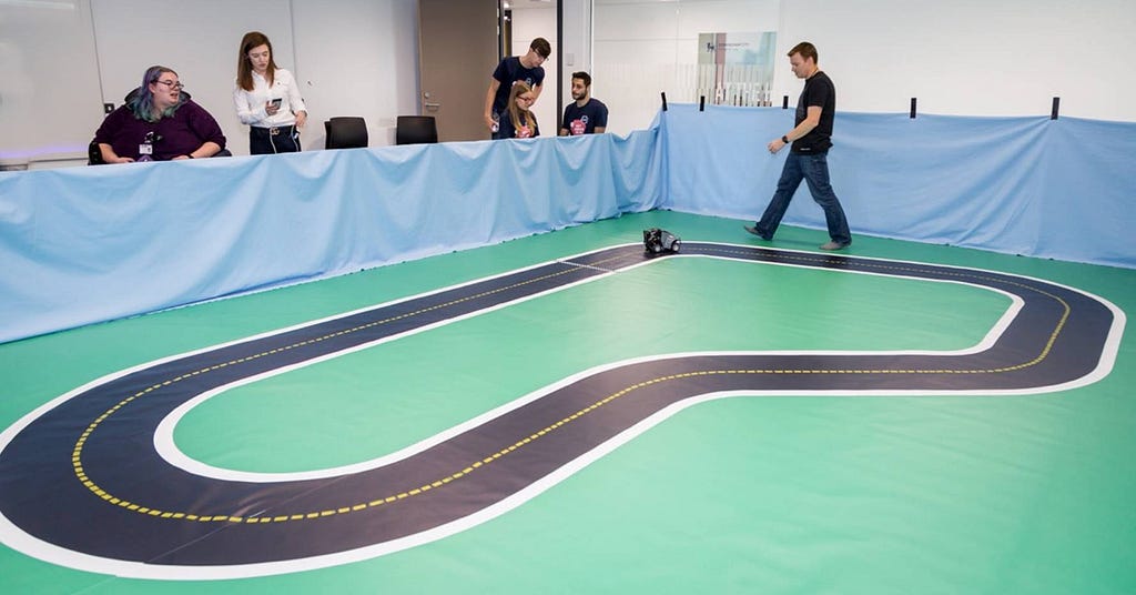 Man walking around a large RC car track