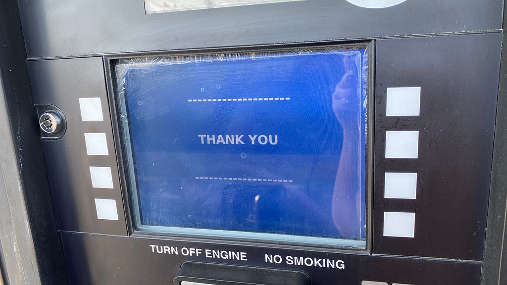 The blue payment screen at a gas pump that says thank you