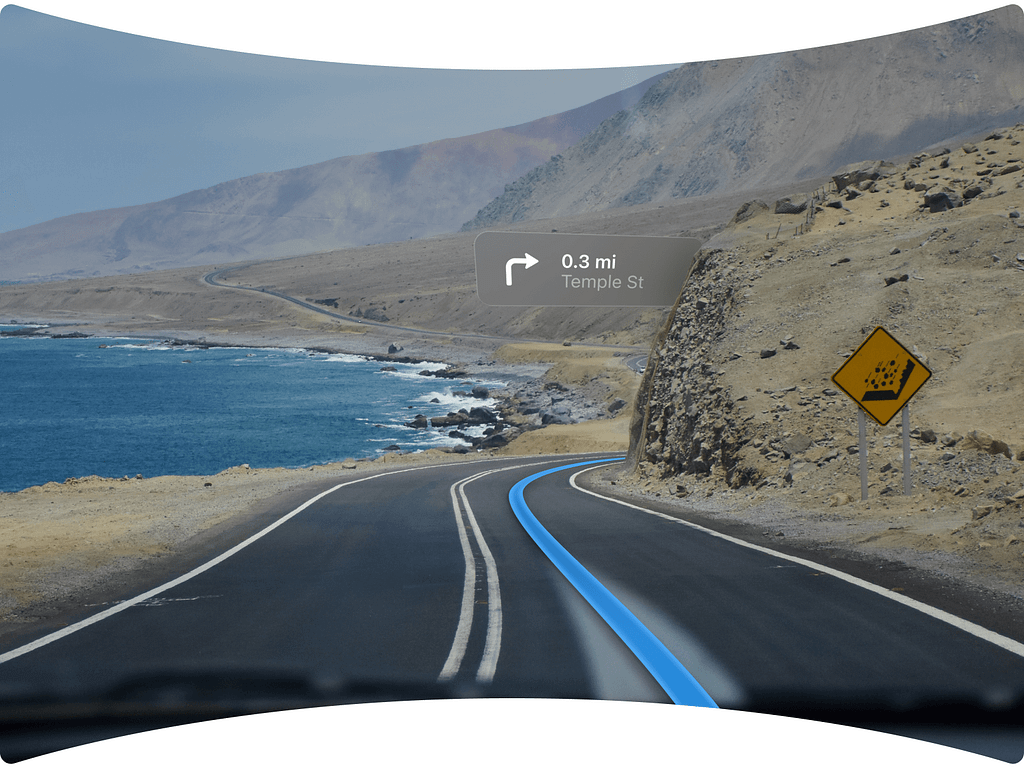 A driver’s view of a coastal road is augmented with AR navigation prompts, indicating a turn onto Temple St. in 0.3 miles.