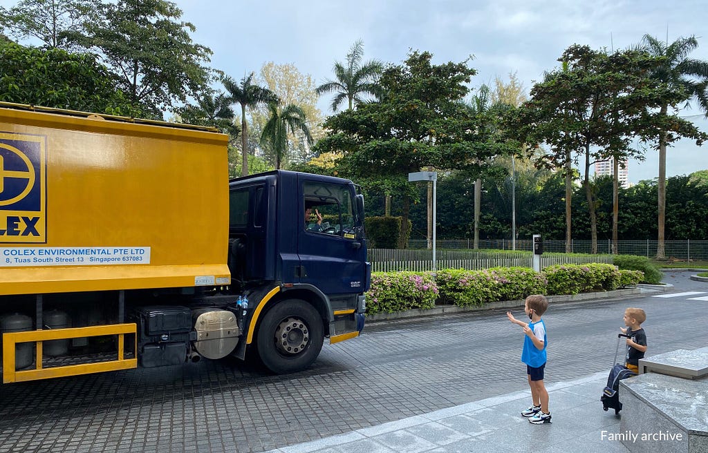 My kids waving to waste collection truck drivers