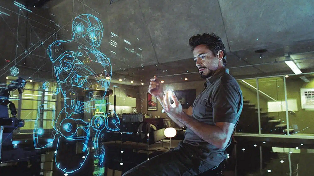 This image depicts Tony Stark engaging with the holographic interface of his Iron Man suit design. It highlights the integration of advanced technology and user interface, making it a perfect visual metaphor for sophisticated UX design in action.