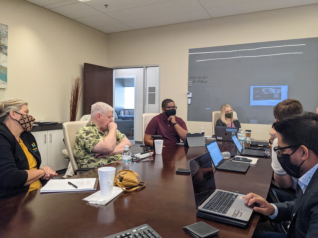 Participants working at a conference table during an in-person training session.