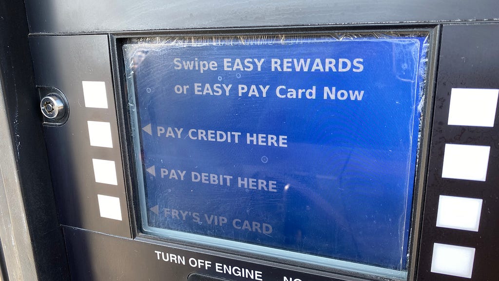 The blue payment screen at a gas pump that asks for the method of payment — credit or debit?