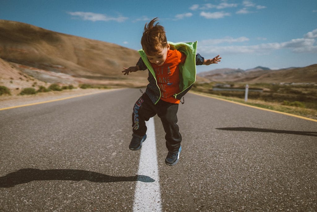 A little boy jumping.