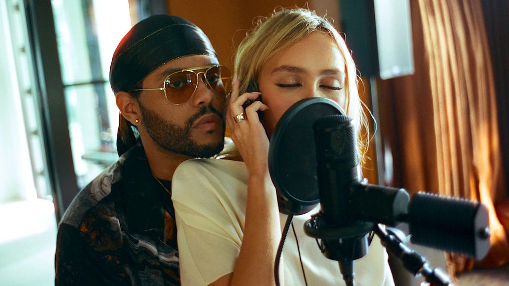 Tedros (The Weekend Or Abel Tesfaye) and Jocelyn (Lily-Rose Depp) producing music in a scene pulled from The Idol. The Idol, 2023, L. Depp, A. Tesfaye — B. Fernandez