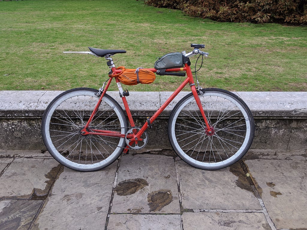 A bike with various bags attached to it.