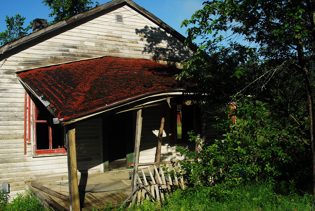 Old wooden house with its porch falling off