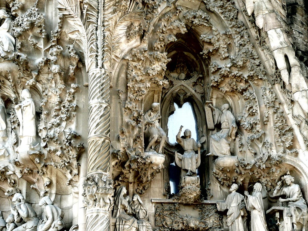 A photo of intricate carved structures on the outside of the Sagrada Família.